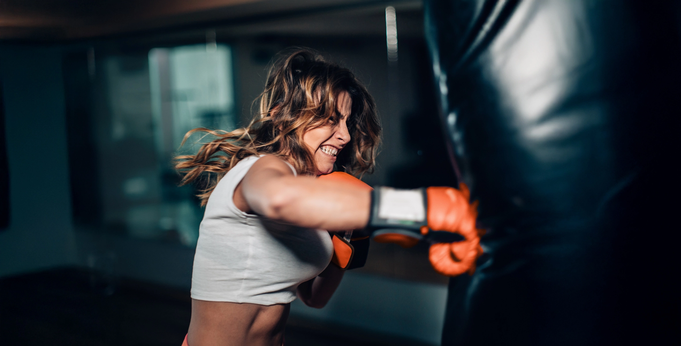 A woman punching a boxing bag